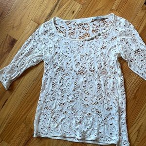 Over a tank top white three-quarter inch sleeve light sweater